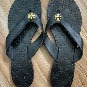 Tory Burch Black Flip Flops with Gold Emblem